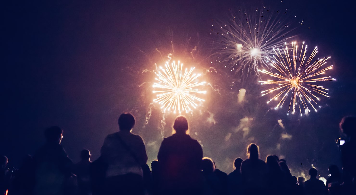 Crowd watching fireworks and celebrating at night
